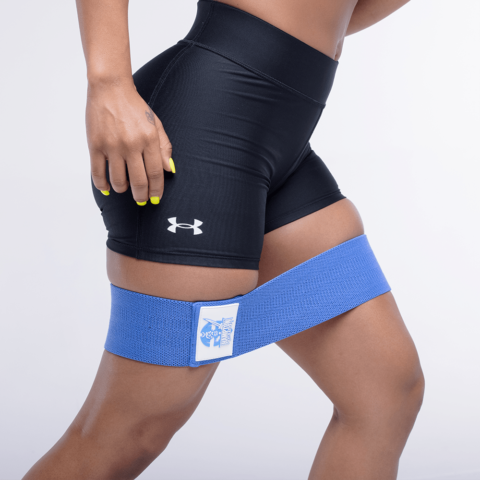 Person wearing blue resistance band on a white background 