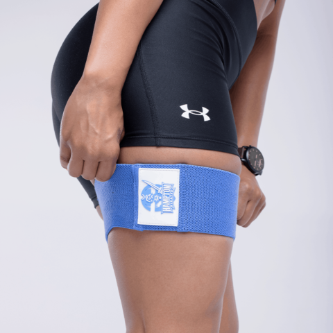 Person wearing blue resistance band on a white background 